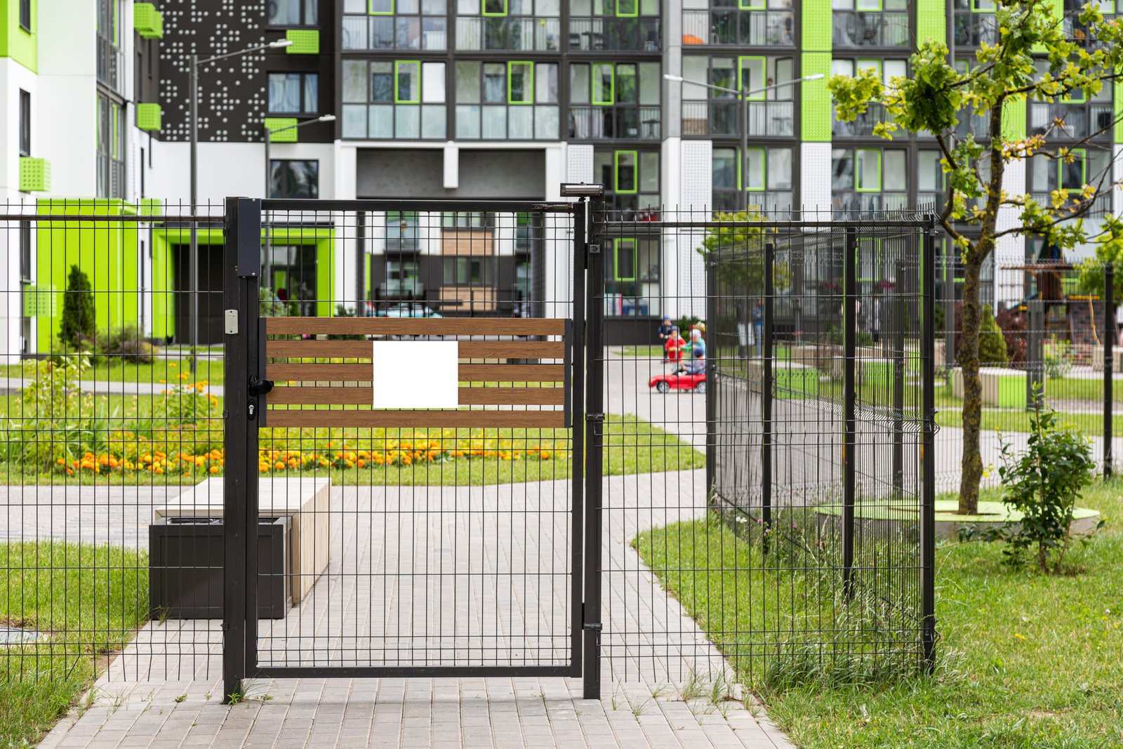 Portillon et clôture noirs devant une résidence collective